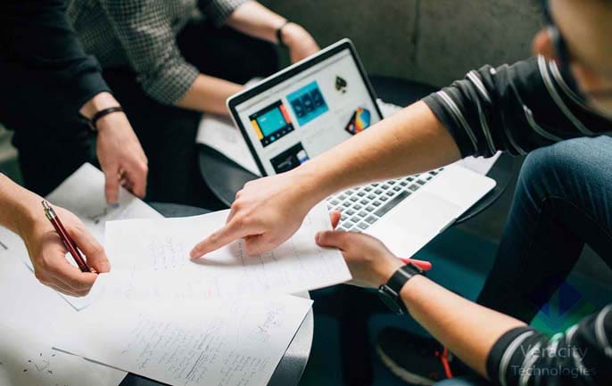 People viewing website performance metrics on laptop